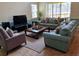 Bright living room features a screen door to a backyard space, and comfortable seating at 8923 Cuban Palm Rd, Kissimmee, FL 34747