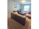 Inviting living room with neutral furniture, entertainment center, and a large window for natural light at 8923 Cuban Palm Rd, Kissimmee, FL 34747