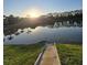 Scenic view of a community pond at sunset with palm trees in the background at 8923 Cuban Palm Rd, Kissimmee, FL 34747