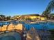 Large community pool with beautiful clubhouse and stone features at 8923 Cuban Palm Rd, Kissimmee, FL 34747