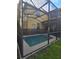 Backyard view of a screened-in pool and patio, with a view of the house exterior at 8923 Cuban Palm Rd, Kissimmee, FL 34747