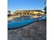 Large community pool with ample seating and beautiful clubhouse in the background at 8923 Cuban Palm Rd, Kissimmee, FL 34747
