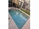 Well-maintained in-ground pool with a sunny deck and a screened enclosure for privacy at 8923 Cuban Palm Rd, Kissimmee, FL 34747