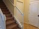 Staircase featuring carpeted steps and a white railing at 8923 Cuban Palm Rd, Kissimmee, FL 34747