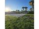 Outdoor sand volleyball court on lush lawn with view of community center, set against a bright, sunny sky at 8923 Cuban Palm Rd, Kissimmee, FL 34747