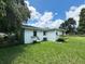 Spacious backyard with mature trees and lush green grass, perfect for outdoor activities at 1400 E Fern Rd, Lakeland, FL 33801