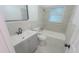 Updated bathroom features gray vanity with white sink and shower-tub combo at 1400 E Fern Rd, Lakeland, FL 33801