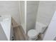 Clean bathroom with a vanity, toilet, and shower, all complemented by gray wood floors at 1400 E Fern Rd, Lakeland, FL 33801
