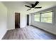 Well-lit bedroom with gray flooring and two windows offering a pleasant view at 1400 E Fern Rd, Lakeland, FL 33801