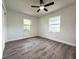 Clean bedroom with wood-look laminate flooring and updated ceiling fan at 1400 E Fern Rd, Lakeland, FL 33801