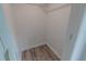 Compact closet with gray wood flooring and fresh white walls, ready for organizing at 1400 E Fern Rd, Lakeland, FL 33801