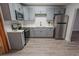 Modern kitchen features stainless steel appliances, grey cabinetry, and stylish countertops and backsplash at 1400 E Fern Rd, Lakeland, FL 33801