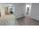 Open-concept living room flows into the kitchen, with wood-look laminate flooring throughout at 1400 E Fern Rd, Lakeland, FL 33801