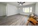 Open-concept living room with wood-look laminate flooring and a light, airy feel at 1400 E Fern Rd, Lakeland, FL 33801