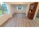 Spacious living room with new floors, white trim, and built in hutch for storage and display at 1400 E Fern Rd, Lakeland, FL 33801