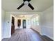 Bright living room with newly installed flooring and abundant natural light from large windows at 1400 E Fern Rd, Lakeland, FL 33801