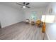 Bright, airy living room features modern ceiling fan and wood-look laminate floors at 1400 E Fern Rd, Lakeland, FL 33801