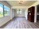 Open living room featuring new floors, a large window, and a classic hutch for storage at 1400 E Fern Rd, Lakeland, FL 33801