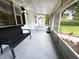 Covered screened porch with seating and neutral epoxy flooring at 1400 E Fern Rd, Lakeland, FL 33801