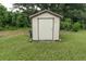 Well-maintained storage shed with a neutral color scheme and lush green surroundings at 1400 E Fern Rd, Lakeland, FL 33801