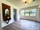 Sun room features ample natural light from the many windows, new flooring, and charming decor at 1400 E Fern Rd, Lakeland, FL 33801