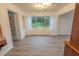 Bright sunroom featuring paned windows, new flooring, and white trim throughout at 1400 E Fern Rd, Lakeland, FL 33801