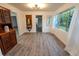 Bright sun room featuring plenty of windows, new flooring, and a built in hutch for display at 1400 E Fern Rd, Lakeland, FL 33801