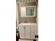 Updated bathroom with a single sink, neutral cabinets, and decorative mirror at 7607 Benji Ridge Trl, Kissimmee, FL 34747