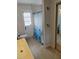 Bright bathroom featuring a shower with a blue curtain, tile flooring, and modern fixtures at 7607 Benji Ridge Trl, Kissimmee, FL 34747
