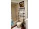 Bathroom with tiled shower, toilet and shelving unit at 7607 Benji Ridge Trl, Kissimmee, FL 34747
