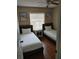 Inviting bedroom featuring twin beds, wood floors, a ceiling fan, and natural light from the window at 7607 Benji Ridge Trl, Kissimmee, FL 34747