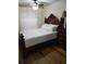 Bright bedroom with a large wooden headboard, matching dresser and a sunlit window at 7607 Benji Ridge Trl, Kissimmee, FL 34747