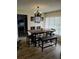 Dining room featuring modern lighting, a wooden table, and a large window at 7607 Benji Ridge Trl, Kissimmee, FL 34747
