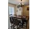Charming dining room featuring a chandelier and a large dining table with seating for six at 7607 Benji Ridge Trl, Kissimmee, FL 34747