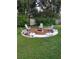 Backyard brick fire pit with Adirondack chairs at 7607 Benji Ridge Trl, Kissimmee, FL 34747