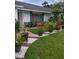 Landscaped front entrance with stone accents and walkway at 7607 Benji Ridge Trl, Kissimmee, FL 34747