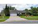 Charming single-story home features a well-manicured front yard and a two-car garage at 7607 Benji Ridge Trl, Kissimmee, FL 34747