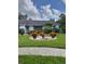 Well-manicured front yard featuring decorative landscaping, plantings, and bench at 7607 Benji Ridge Trl, Kissimmee, FL 34747