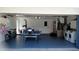 Spacious garage with a ping pong table, washer, dryer and ample storage at 7607 Benji Ridge Trl, Kissimmee, FL 34747