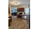 Well-lit kitchen features stainless steel appliances and modern wood flooring at 7607 Benji Ridge Trl, Kissimmee, FL 34747