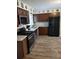 Well-lit kitchen features stainless steel appliances and modern wood flooring at 7607 Benji Ridge Trl, Kissimmee, FL 34747