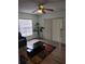 Comfortable living room with a large window, a ceiling fan, and a cozy seating area at 7607 Benji Ridge Trl, Kissimmee, FL 34747