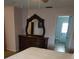 Spacious main bedroom with a dresser, mirror, and ensuite bathroom at 7607 Benji Ridge Trl, Kissimmee, FL 34747