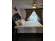 Spacious main bedroom with a comfortable bed, ceiling fan, and decorative curtains at 7607 Benji Ridge Trl, Kissimmee, FL 34747