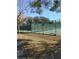 Well-maintained tennis court with green fencing offers a great space for recreation and exercise at 7607 Benji Ridge Trl, Kissimmee, FL 34747