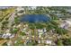Stunning aerial view of the neighborhood homes surrounding a serene lake and cityscape at 1048 W Lime St, Lakeland, FL 33815