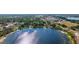 Expansive aerial view of a tranquil lake, showcasing the surrounding residential area and distant cityscape at 1048 W Lime St, Lakeland, FL 33815