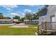 Exterior backyard with a driveway, shed, concrete patio and mature trees at 1048 W Lime St, Lakeland, FL 33815