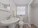 Clean and bright bathroom with a pedestal sink and modern fixtures at 1048 W Lime St, Lakeland, FL 33815