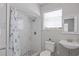 Modern bathroom features tiled shower, bright window, decorative plant and vanity at 1048 W Lime St, Lakeland, FL 33815